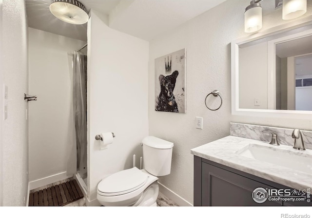 1510 22nd Ave, Longmont, CO 80501 - bathroom featuring vanity, toilet, baseboards, and a shower with shower curtain
