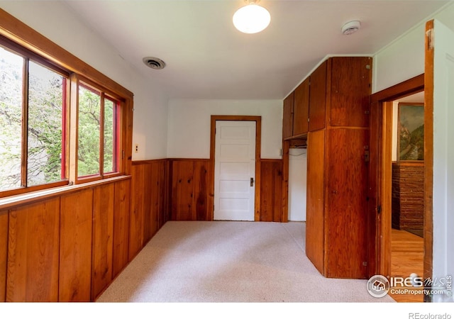35106 Boulder Canyon Dr, Boulder, CO 80302 - carpeted empty room featuring wainscoting, a smoke detector, and wood walls