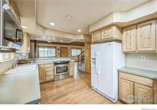 24192 W County Road 74e, Red Feather Lakes, CO 80545 - kitchen featuring stainless steel appliances, light brown cabinetry, a sink, light wood finished floors, and recessed lighting
