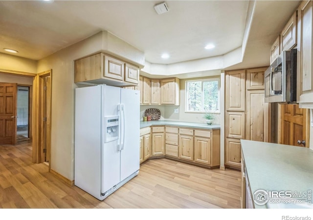 24192 W County Road 74e, Red Feather Lakes, CO 80545 - kitchen with white fridge with ice dispenser, light wood-style flooring, light brown cabinets, light countertops, and recessed lighting