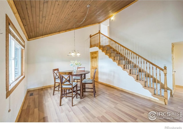 24192 W County Road 74e, Red Feather Lakes, CO 80545 - dining space with wood finished floors, wooden ceiling, crown molding, stairs, and a chandelier