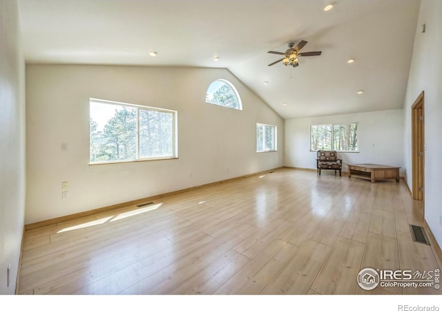 24192 W County Road 74e, Red Feather Lakes, CO 80545 - unfurnished living room with a ceiling fan, light wood-style floors, high vaulted ceiling, and baseboards