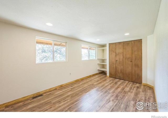 24192 W County Road 74e, Red Feather Lakes, CO 80545 - unfurnished bedroom with light wood-style flooring, a closet, baseboards, and recessed lighting