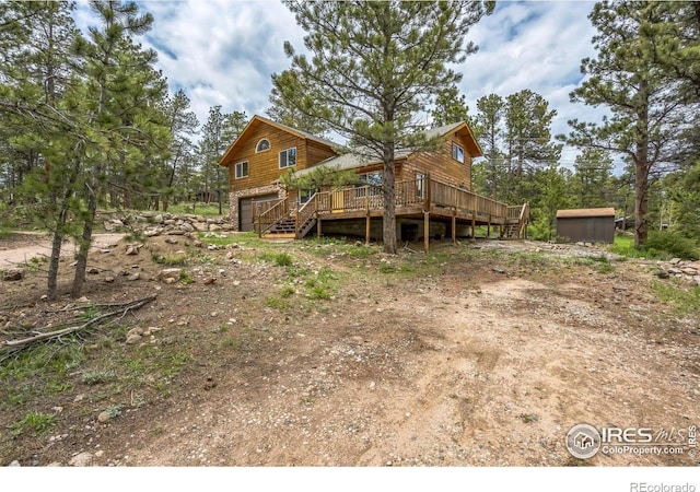 24192 W County Road 74e, Red Feather Lakes, CO 80545 - rear view of house with a deck and an attached garage