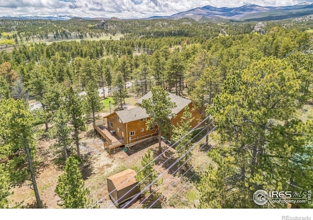 24192 W County Road 74e, Red Feather Lakes, CO 80545 - view from above of property featuring a heavily wooded area and a mountain backdrop