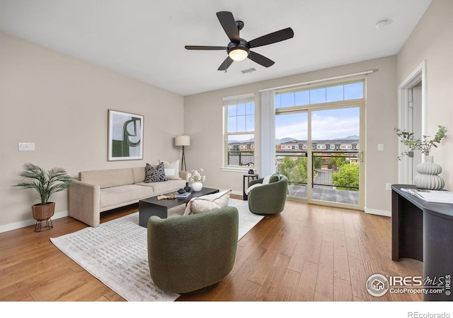 13598 Via Varra Unit 404, Broomfield, CO 80020 - living room with hardwood / wood-style floors, baseboards, and a ceiling fan