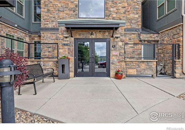 13598 Via Varra Unit 404, Broomfield, CO 80020 - entrance to property featuring french doors and stone siding