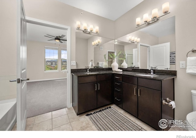 13598 Via Varra Unit 404, Broomfield, CO 80020 - bathroom featuring double vanity, a ceiling fan, toilet, tile patterned flooring, and a bathtub