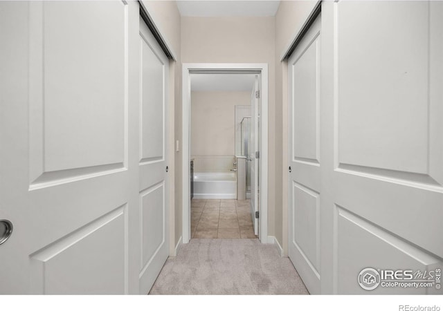 13598 Via Varra Unit 404, Broomfield, CO 80020 - hallway featuring light colored carpet and baseboards