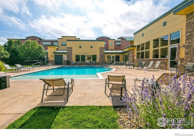 13598 Via Varra Unit 404, Broomfield, CO 80020 - community pool featuring a patio