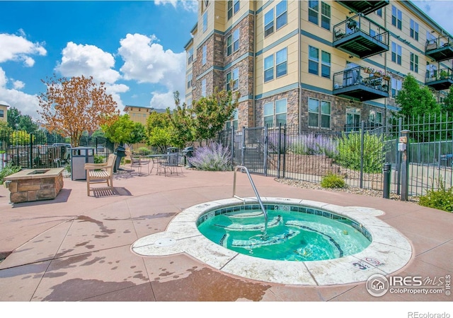 13598 Via Varra Unit 404, Broomfield, CO 80020 - view of swimming pool with a community hot tub, a patio, and an outdoor fire pit