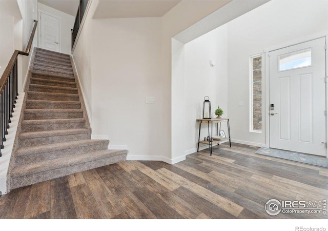 1257 Wild Basin Rd, Severance, CO 80550 - foyer entrance with wood finished floors, stairs, and baseboards