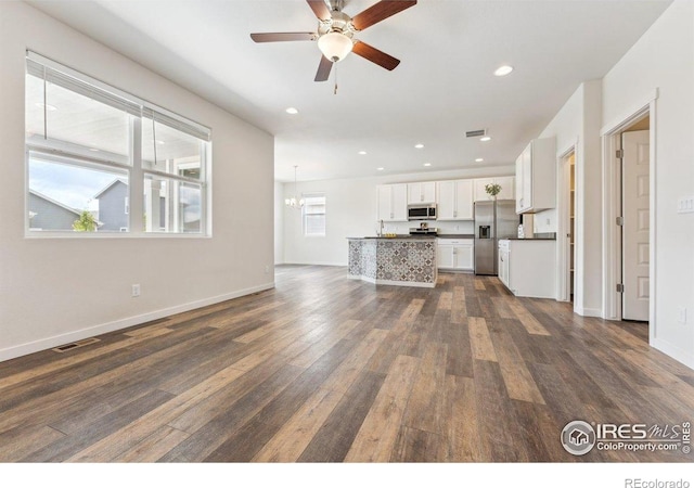 1257 Wild Basin Rd, Severance, CO 80550 - unfurnished living room featuring dark wood-style floors, ceiling fan, a chandelier, recessed lighting, and baseboards