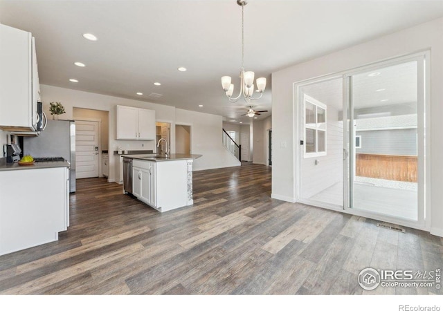 1257 Wild Basin Rd, Severance, CO 80550 - kitchen with open floor plan, a chandelier, stainless steel appliances, dark countertops, and recessed lighting