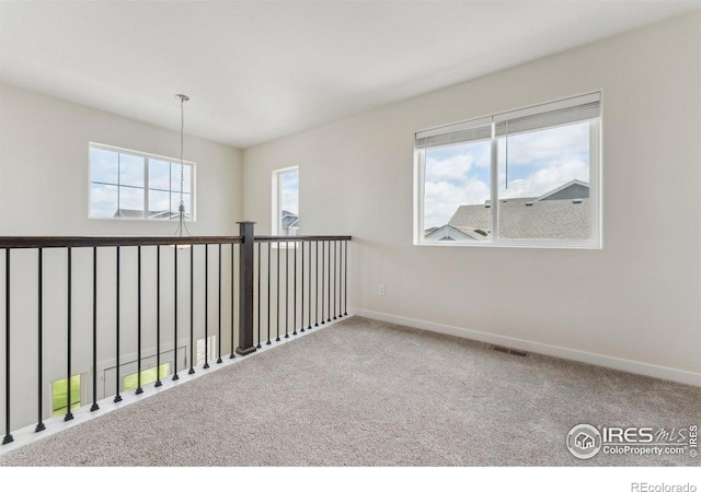 1257 Wild Basin Rd, Severance, CO 80550 - empty room with baseboards, carpet floors, and a chandelier