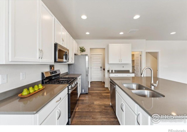 1257 Wild Basin Rd, Severance, CO 80550 - kitchen with appliances with stainless steel finishes, a sink, dark wood-style flooring, white cabinets, and dark countertops