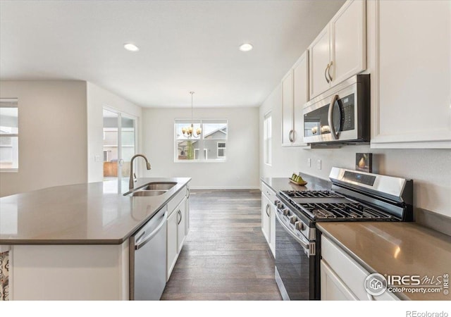 1257 Wild Basin Rd, Severance, CO 80550 - kitchen featuring stainless steel appliances, a sink, healthy amount of natural light, dark wood finished floors, and recessed lighting