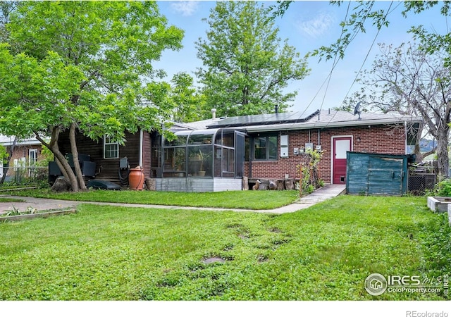 50 S 31st St, Boulder, CO 80305 - rear view of property featuring solar panels, brick siding, and a sunroom