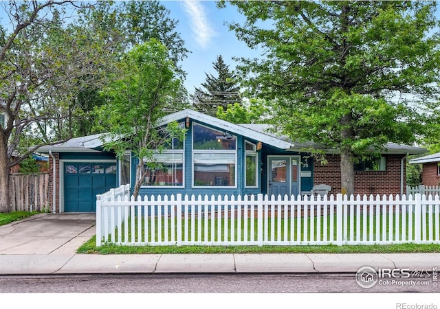 50 S 31st St, Boulder, CO 80305 - view of front of property with a fenced front yard, driveway, and brick siding
