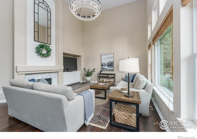 2204 Lasalle St, Superior, CO 80027 - living room with a towering ceiling, baseboards, dark wood-style flooring, plenty of natural light, and a chandelier