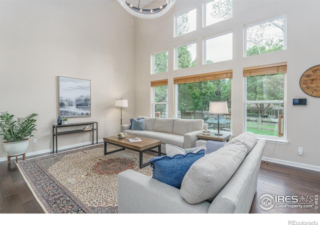 2204 Lasalle St, Superior, CO 80027 - living room with plenty of natural light, a towering ceiling, dark wood-type flooring, baseboards, and a chandelier