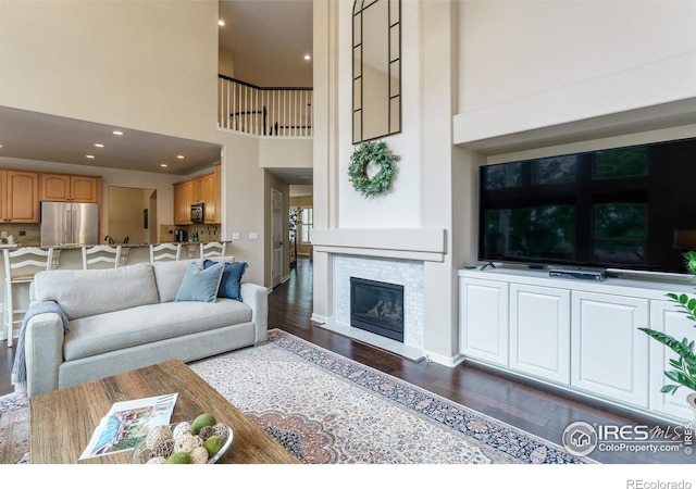 2204 Lasalle St, Superior, CO 80027 - living area with a towering ceiling, dark wood-style floors, and a glass covered fireplace