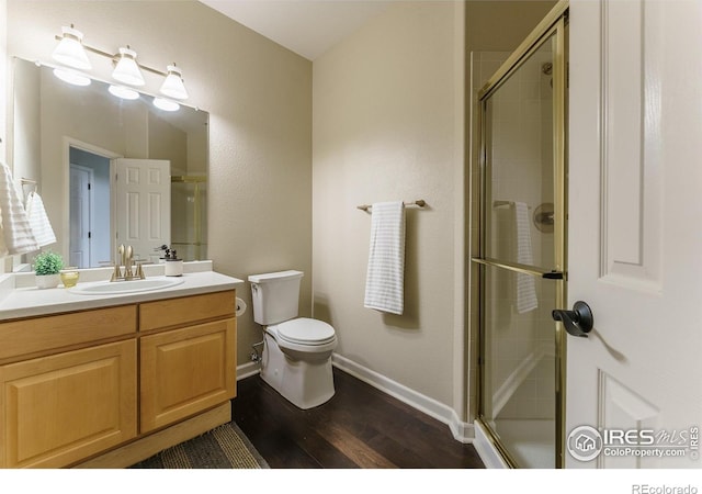 2204 Lasalle St, Superior, CO 80027 - full bathroom with wood finished floors, toilet, vanity, a tile shower, and baseboards