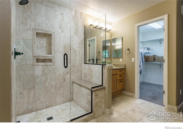 2204 Lasalle St, Superior, CO 80027 - bathroom with a stall shower, vanity, a walk in closet, and marble look tile flooring