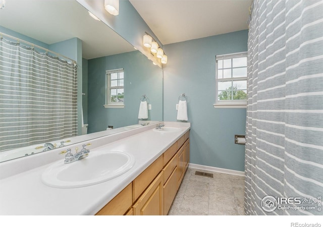 2204 Lasalle St, Superior, CO 80027 - full bathroom featuring double vanity, healthy amount of natural light, tile patterned flooring, and baseboards