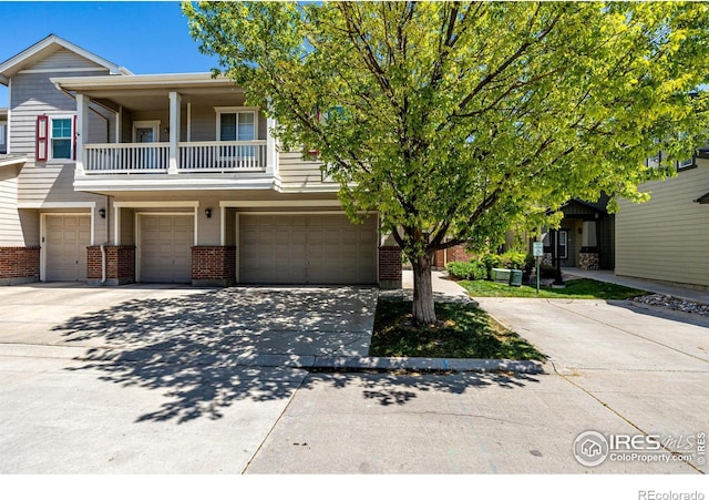 13024 Grant Cir W Unit A, Thornton, CO 80241 - multi unit property with an attached garage, brick siding, driveway, and a balcony