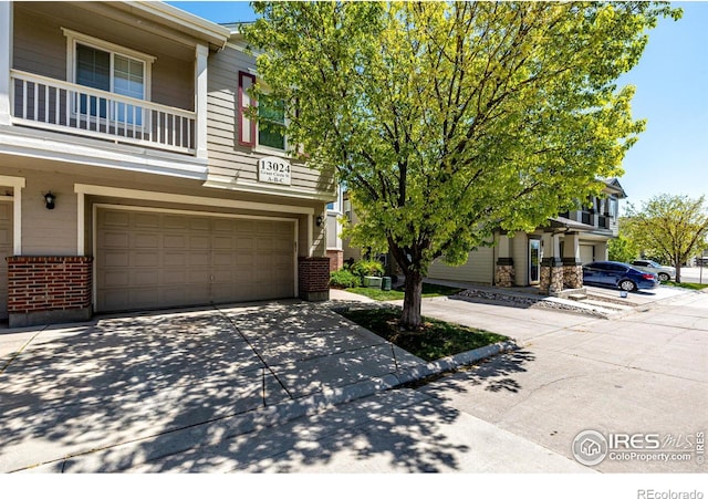 13024 Grant Cir W Unit A, Thornton, CO 80241 - multi unit property with brick siding, a garage, and concrete driveway