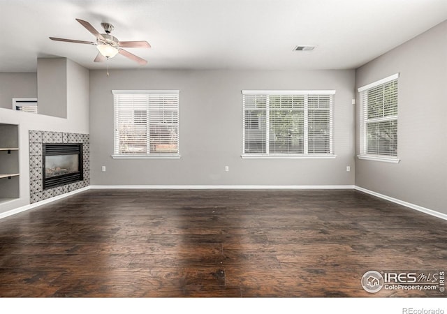 13024 Grant Cir W Unit A, Thornton, CO 80241 - unfurnished living room featuring healthy amount of natural light, wood finished floors, baseboards, and a fireplace