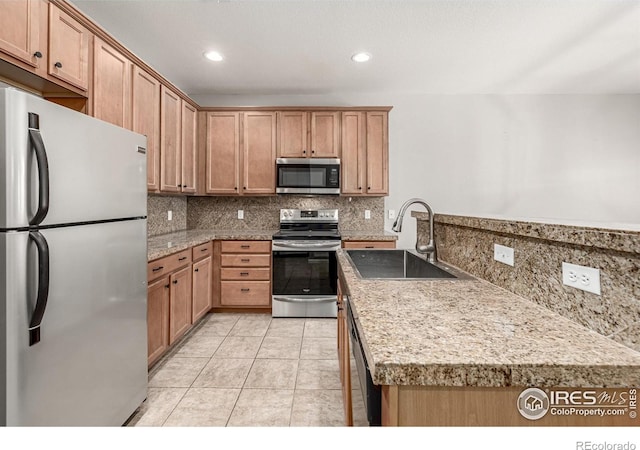 13024 Grant Cir W Unit A, Thornton, CO 80241 - kitchen with appliances with stainless steel finishes, a sink, backsplash, recessed lighting, and light tile patterned flooring