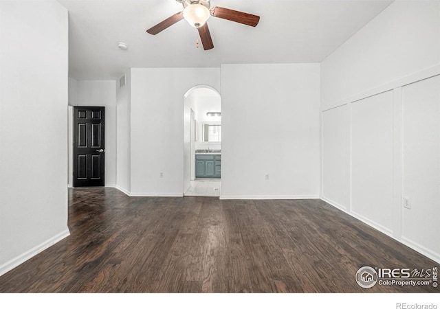 13024 Grant Cir W Unit A, Thornton, CO 80241 - spare room with arched walkways, ceiling fan, wood finished floors, and baseboards