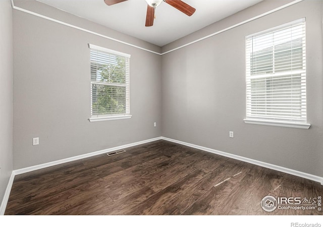 13024 Grant Cir W Unit A, Thornton, CO 80241 - spare room featuring a ceiling fan, dark wood finished floors, and baseboards