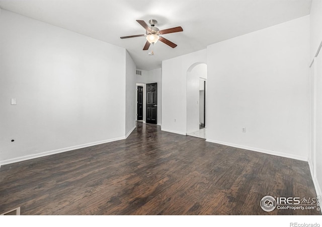 13024 Grant Cir W Unit A, Thornton, CO 80241 - unfurnished room featuring arched walkways, ceiling fan, dark wood finished floors, baseboards, and vaulted ceiling
