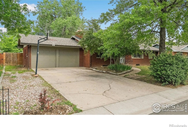 1200 Emigh St, Fort Collins, CO 80524 - view of front of house with a garage, concrete driveway, and brick siding