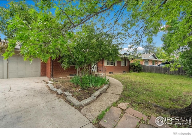 1200 Emigh St, Fort Collins, CO 80524 - obstructed view of property with brick siding, driveway, and a garage