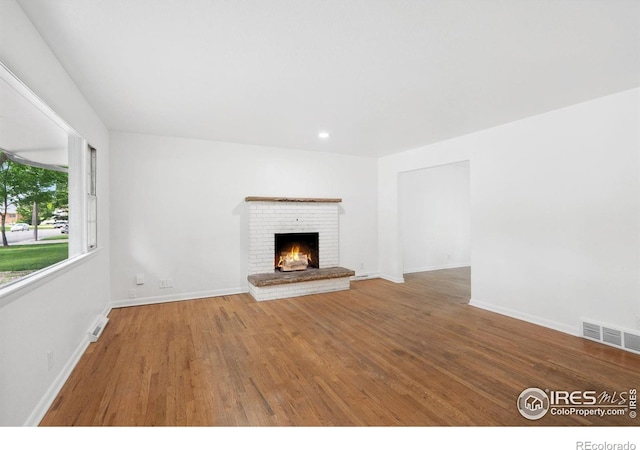 1200 Emigh St, Fort Collins, CO 80524 - unfurnished living room with wood finished floors, a fireplace, baseboards, and recessed lighting