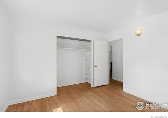 1200 Emigh St, Fort Collins, CO 80524 - unfurnished bedroom featuring wood finished floors, a closet, and baseboards