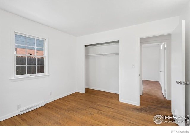 1200 Emigh St, Fort Collins, CO 80524 - unfurnished bedroom with wood finished floors, baseboards, and a closet