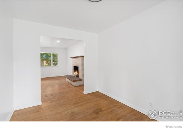 1200 Emigh St, Fort Collins, CO 80524 - unfurnished living room featuring wood finished floors, a fireplace, and baseboards