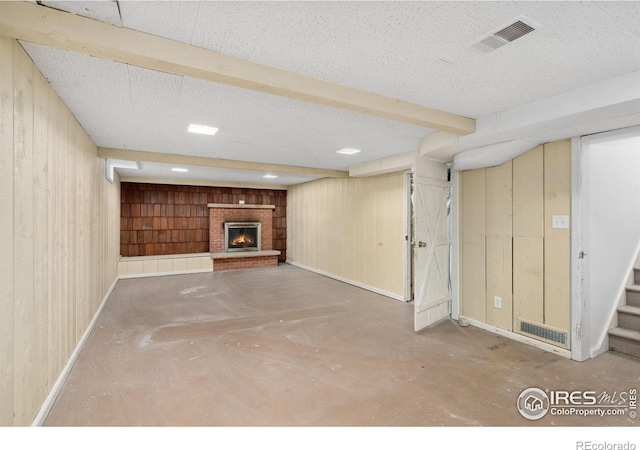 1200 Emigh St, Fort Collins, CO 80524 - finished basement with wooden walls, a fireplace, stairway, and baseboards