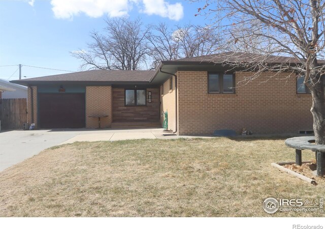815 Park St, Fort Morgan, CO 80701 - single story home featuring a garage, brick siding, and driveway