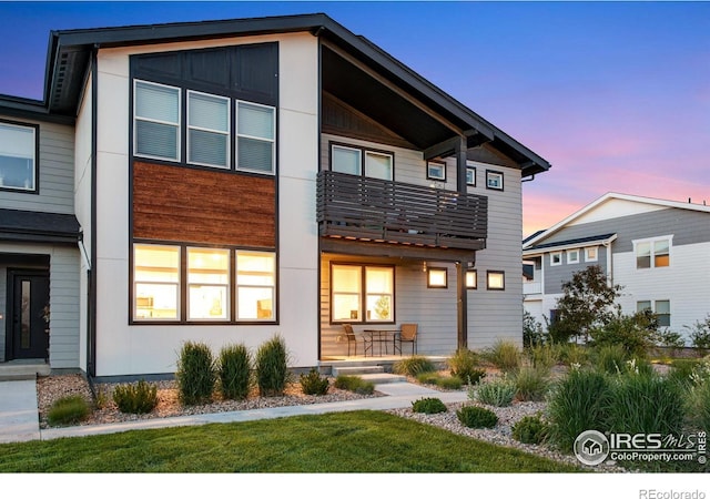 2086 Autumn Moon Dr Unit 7, Windsor, CO 80550 - view of front of home with a balcony, covered porch, and a front yard