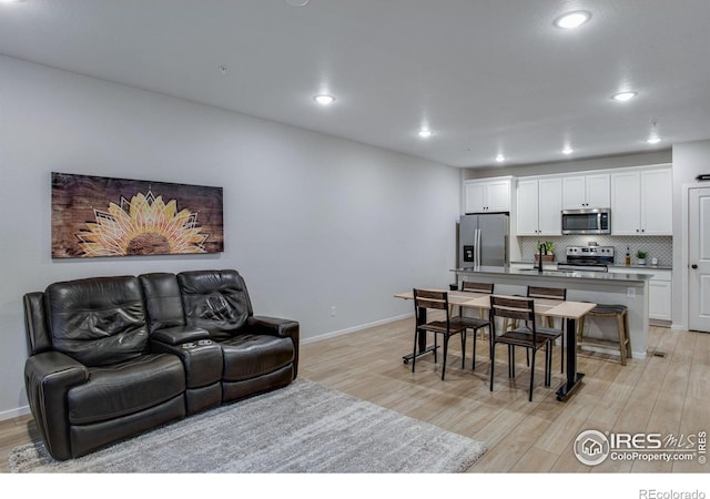 2086 Autumn Moon Dr Unit 7, Windsor, CO 80550 - living room featuring light wood finished floors, recessed lighting, and baseboards