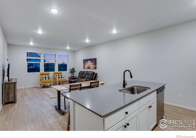2086 Autumn Moon Dr Unit 7, Windsor, CO 80550 - kitchen featuring a sink, stainless steel dishwasher, light wood-style flooring, white cabinetry, and recessed lighting