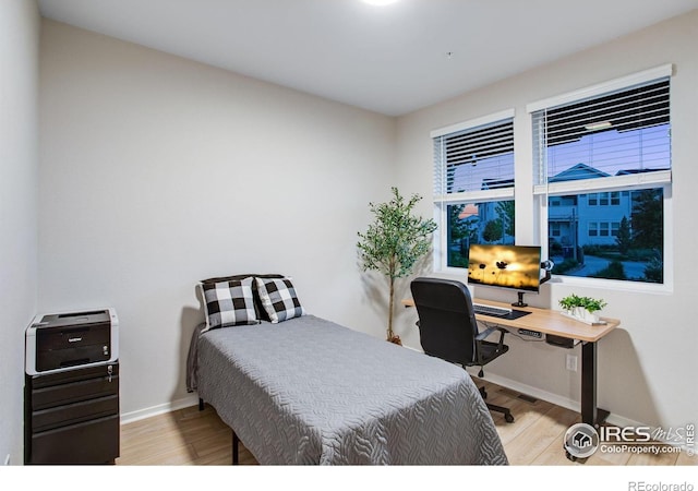 2086 Autumn Moon Dr Unit 7, Windsor, CO 80550 - bedroom with wood finished floors, baseboards, and a desk