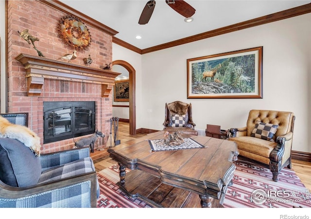 20360 County Road 3, Berthoud, CO 80513 - living room with wood finished floors, baseboards, ornamental molding, ceiling fan, and a brick fireplace