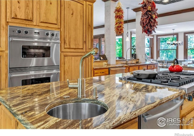 20360 County Road 3, Berthoud, CO 80513 - kitchen featuring stainless steel appliances, a sink, dark stone counters, and a chandelier